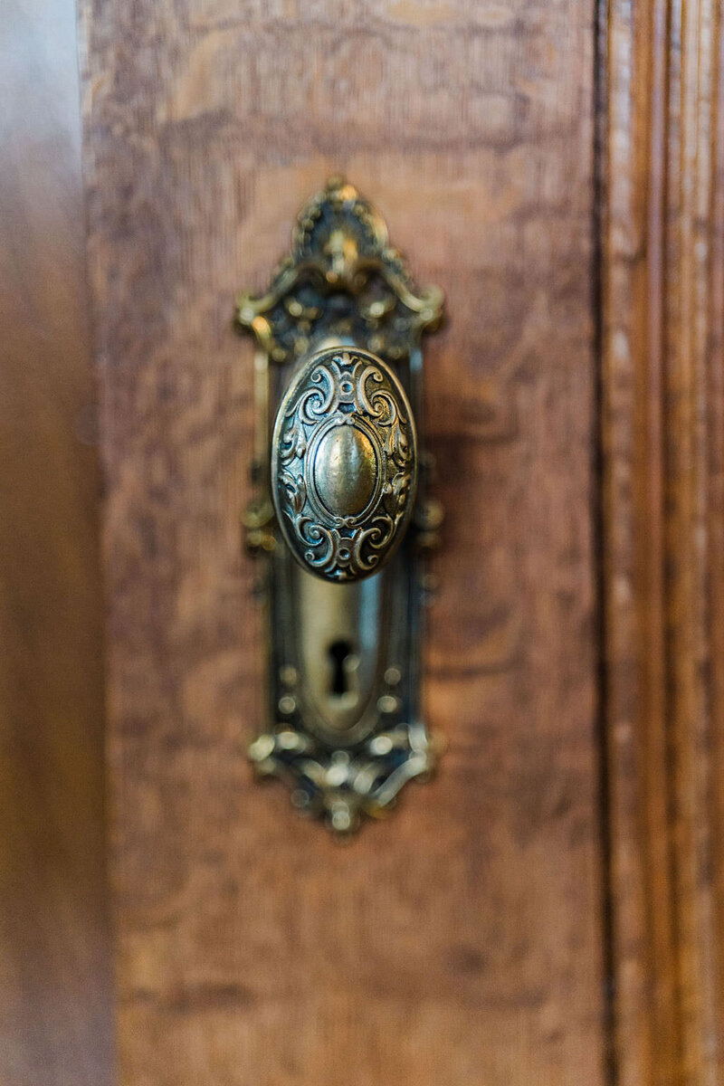 old historic door knob and lock on wooden door