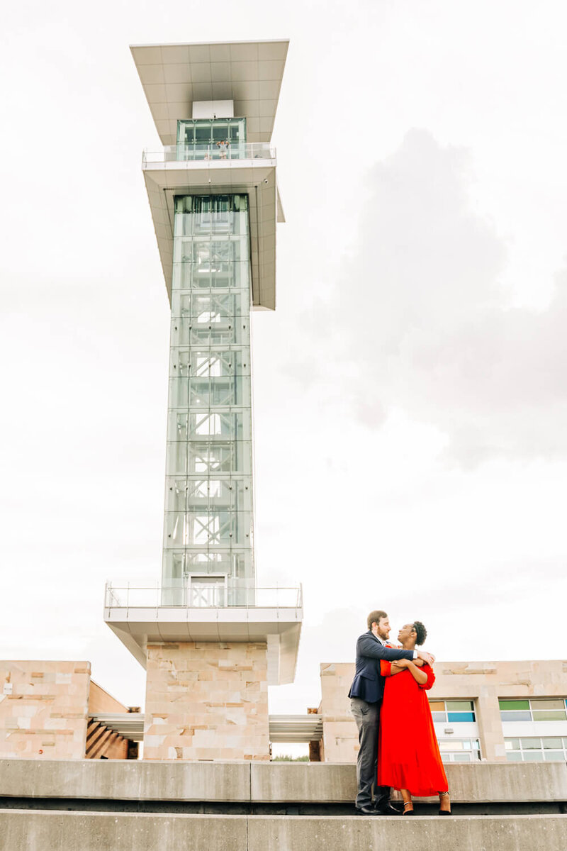An engaged couple embraces in downtown Cincinnati, Ohio, for engagement photos.