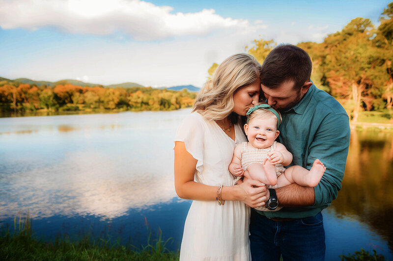 Parents embrace their baby during a Family Photoshoot in Asheville, NC.