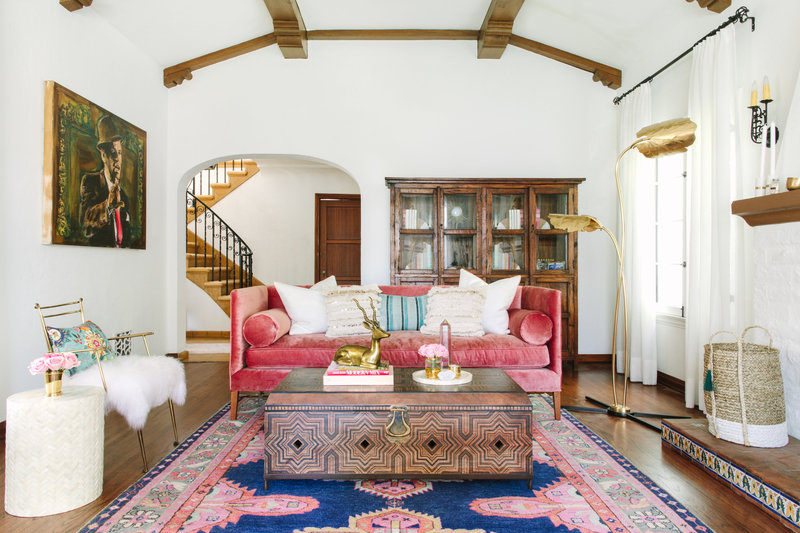 Spanish Colonial Living room with pink velvet sofa, Caitlin Wilson navy Kismet rug, Moroccan coffee table, and leather lounge chair.