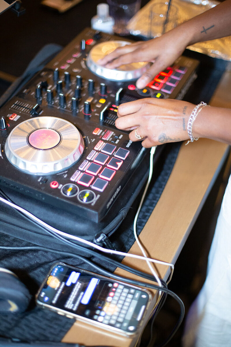 The Hart and Main DJ hands hover above her turntables and mixers