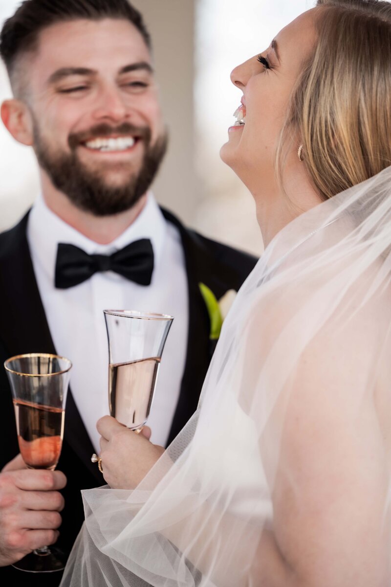 Feel the genuine joy in this candid shot of Emily and Matt laughing together on their special day. This image captures the spontaneous moments that often become the most cherished memories, perfect for couples who value authenticity in their wedding photos.