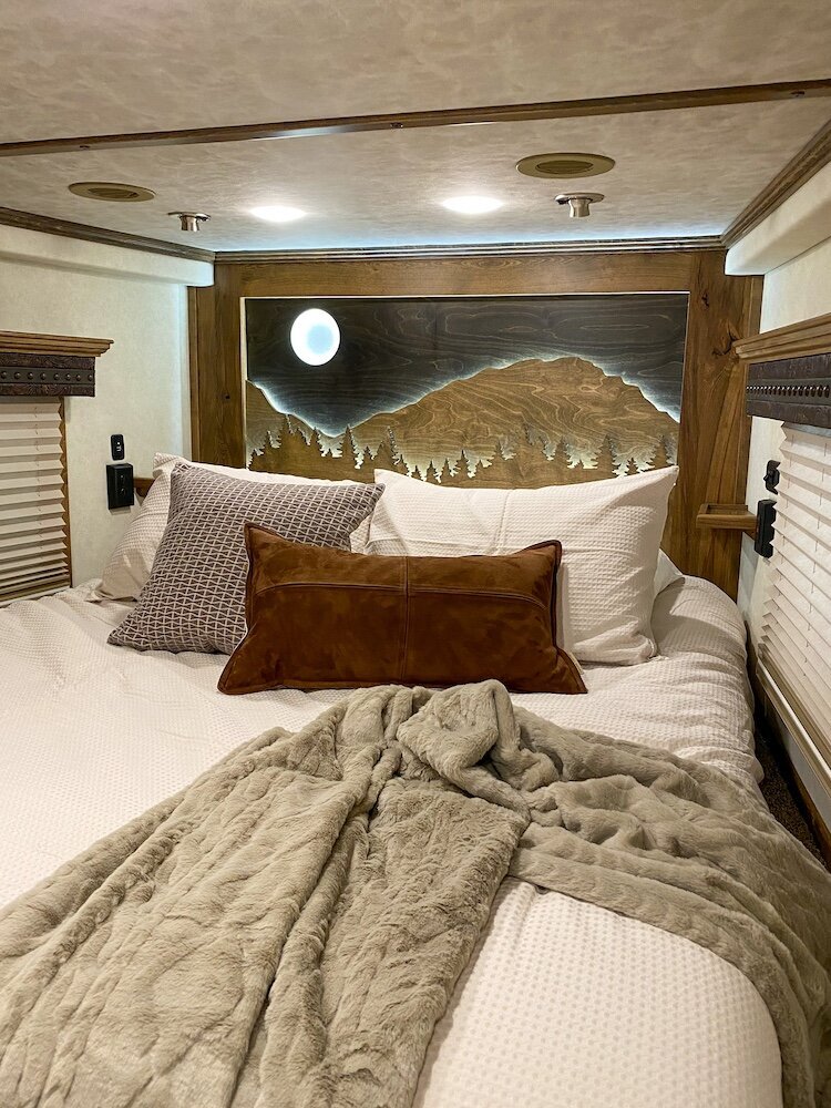 A bed inside the loft of a luxury horse trailer