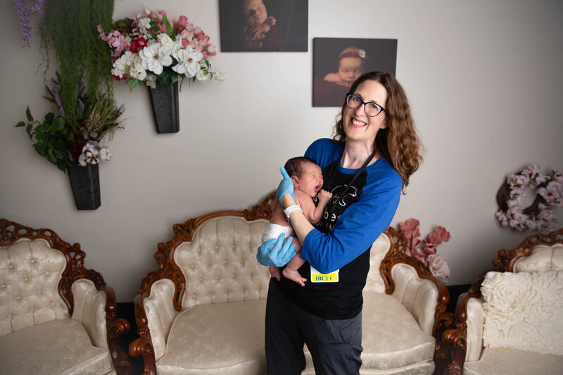 Woman smiling while holding a baby