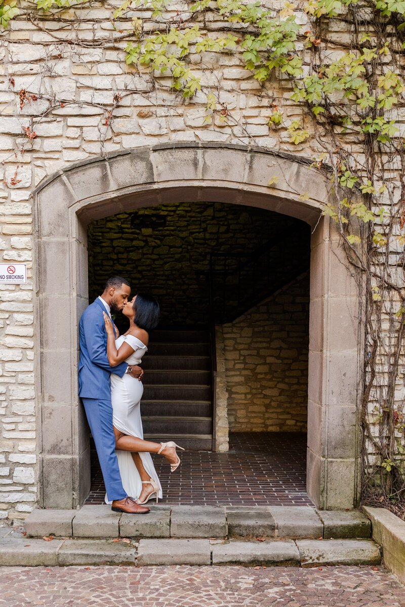 bride and groom sharing a kiss in a doorway during their irving texas wedding