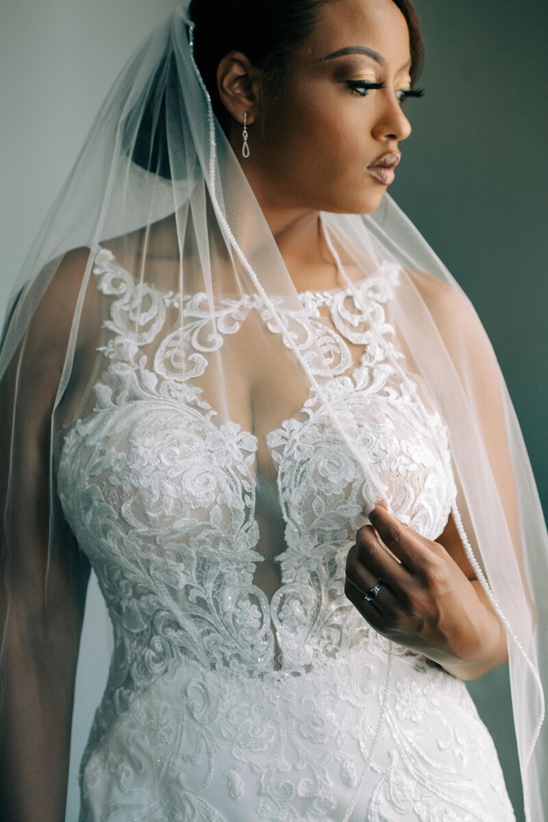 A bride in a white wedding dress with a veil captured by photographer for destination weddings Britt Elizabeth.