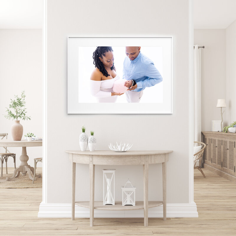 Fine art photography from a newborn session hangs printed on a wall