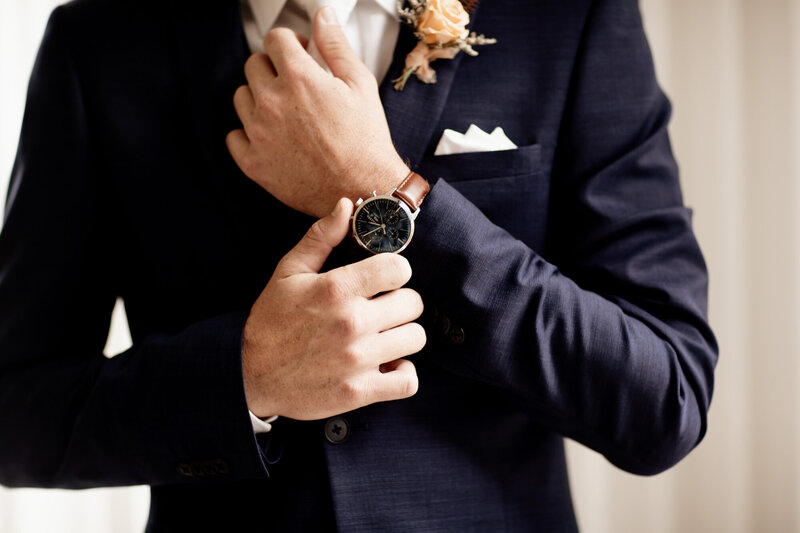 Groom holding his watch