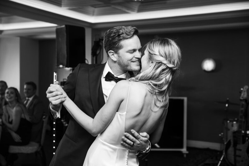 Black and white photo of a bride and groom having their first dance at their wedding reception at La Valencia Hotel in San Diego.