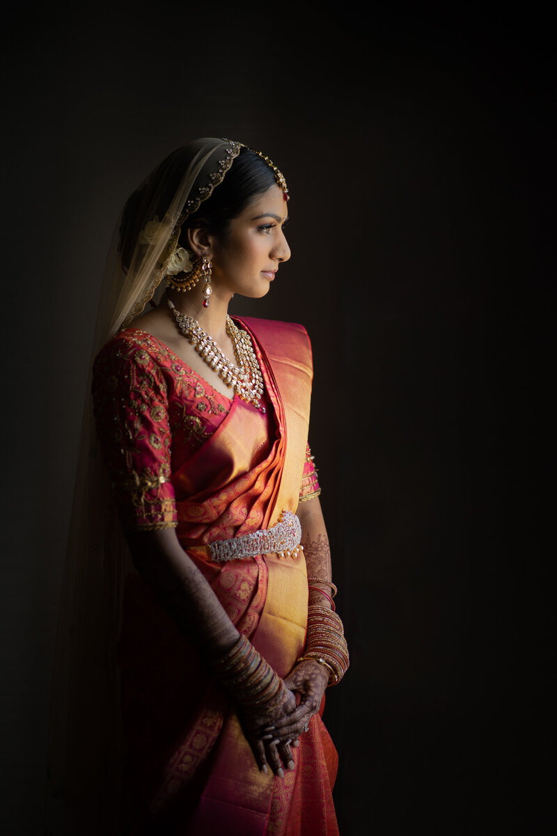 A bride in traditional clothes looking off to the side