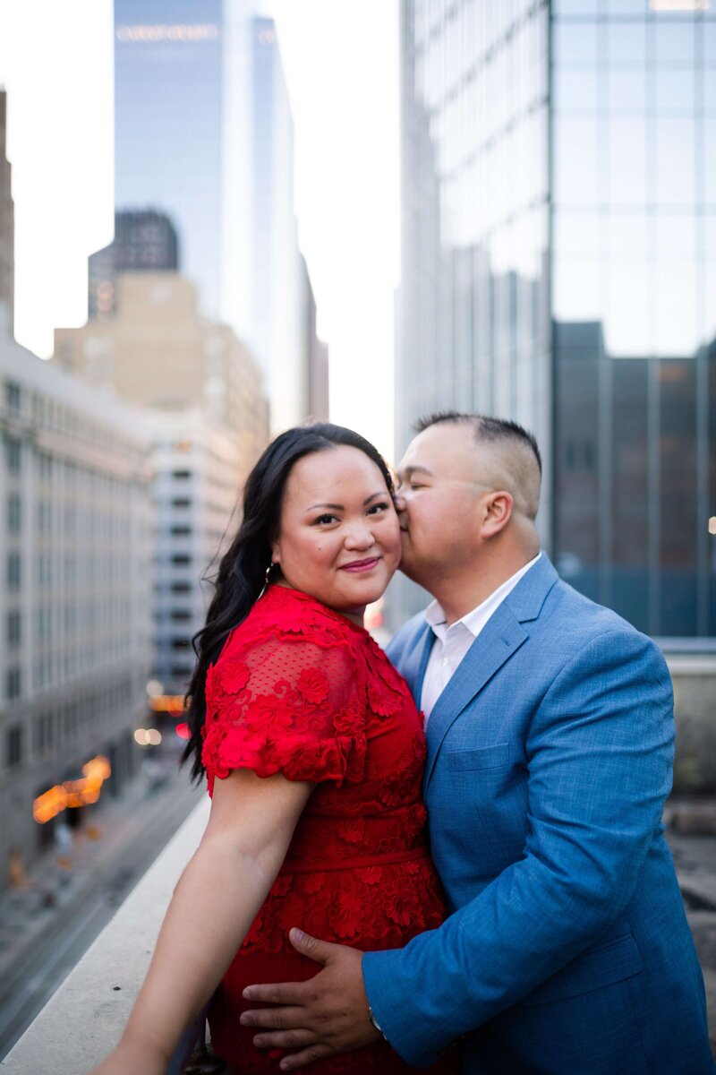 groom kisses bride to be on a rooftop in downtown Houston by Swish and Click Photography