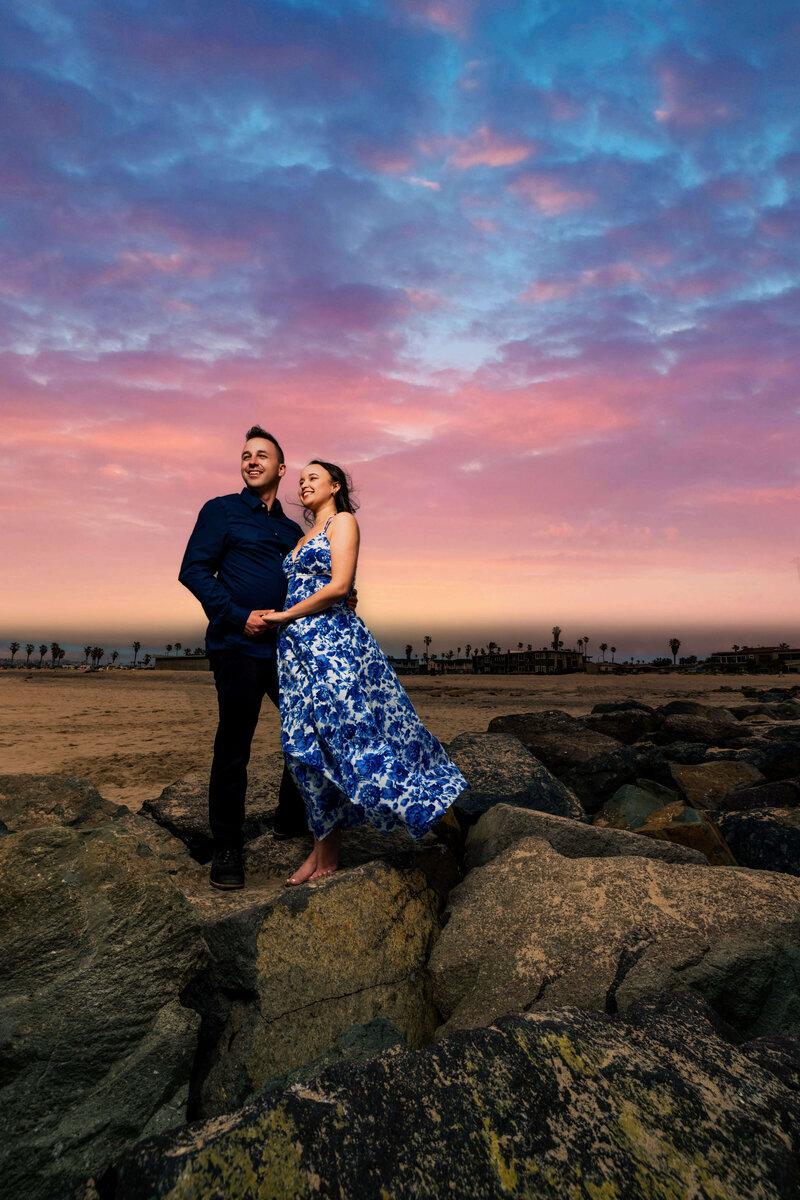Couple portraits of Paul Michael Cooper, San Diego wedding photographer and his partner at sunset standing on some rocks
