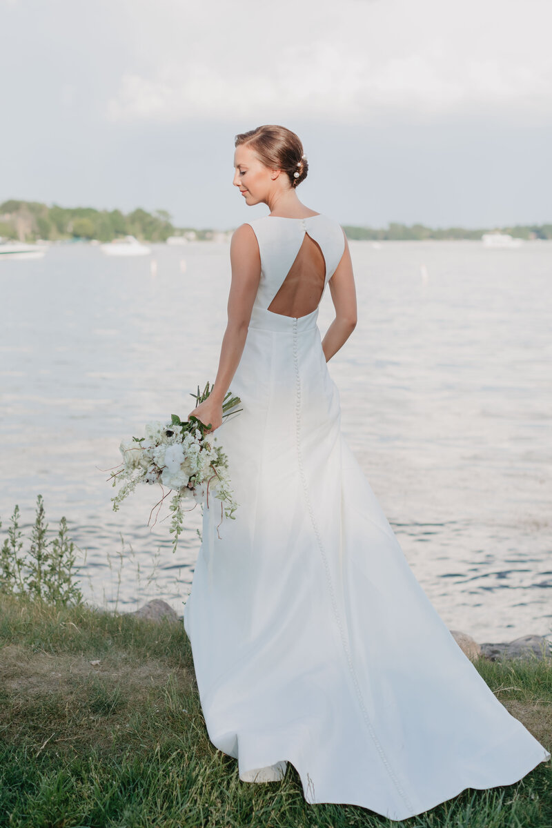 bride posed in front of MN lake