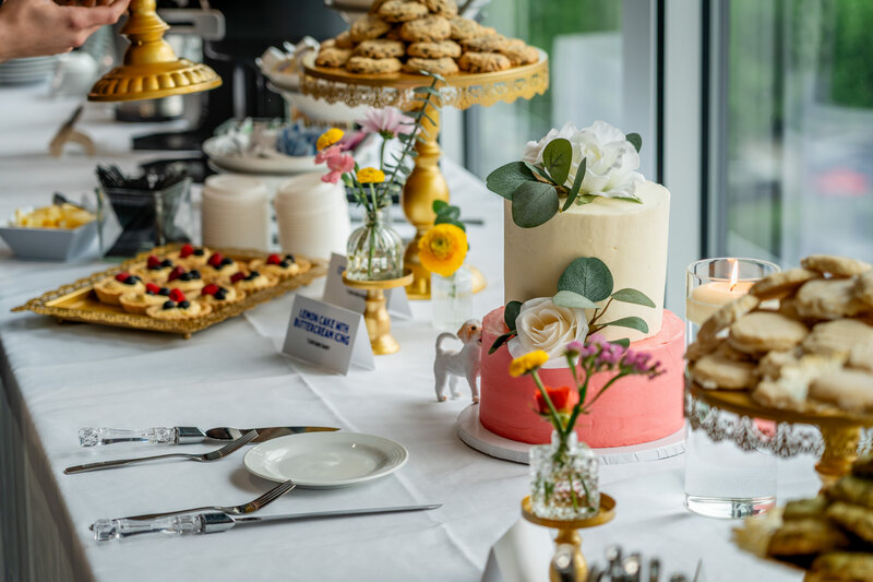 Wedding dessert table with cakes, pastries, and fresh fruit accents – photographed by wedding photographer Niko Coric – Lumen Clarity Media