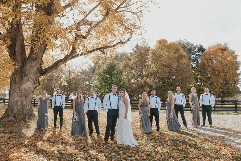bride and groom with bridal party in fall wedding