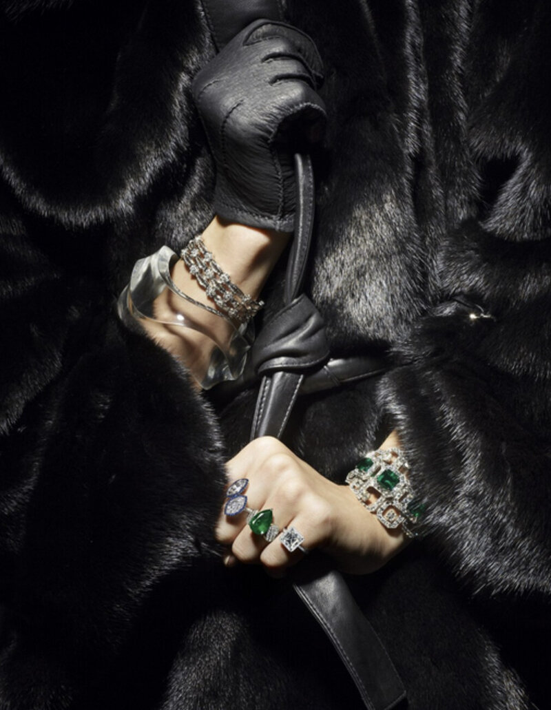 woman wearing black fur coat with rings