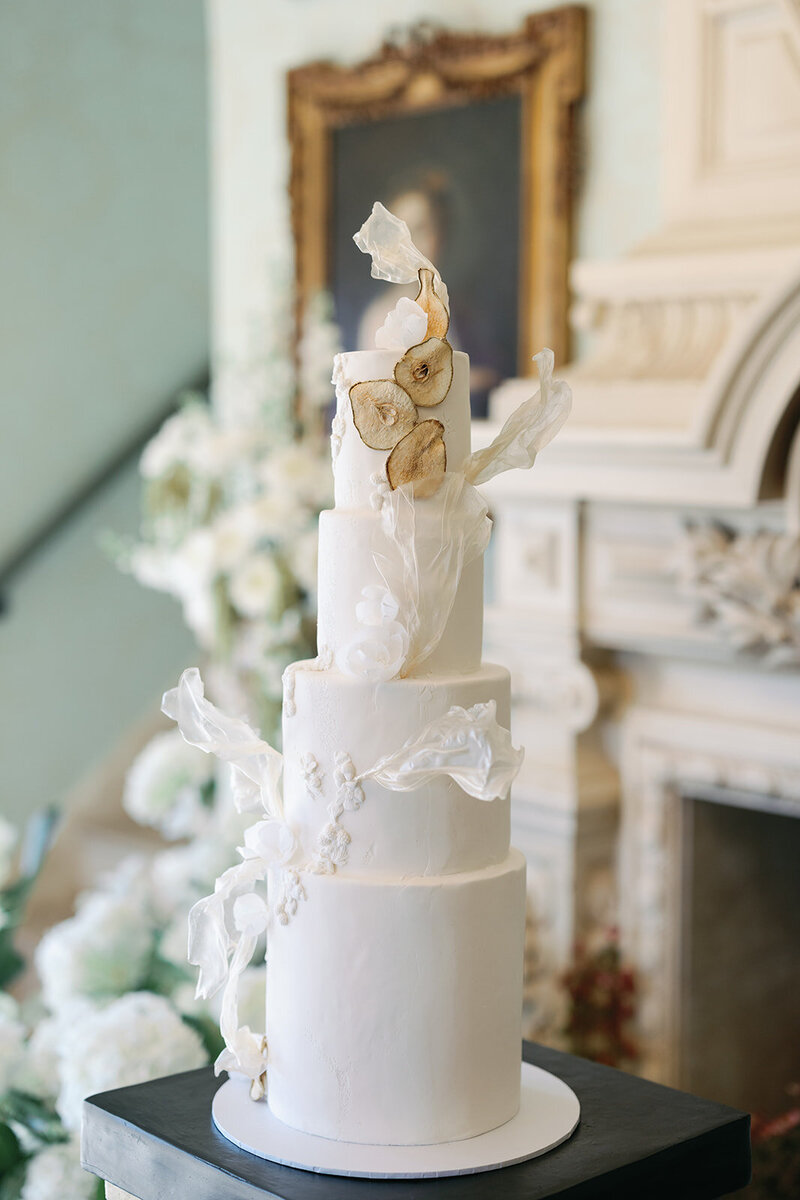 Fine art wedding cake at Dover Hall with dried fruit white fondant and rice paper sails