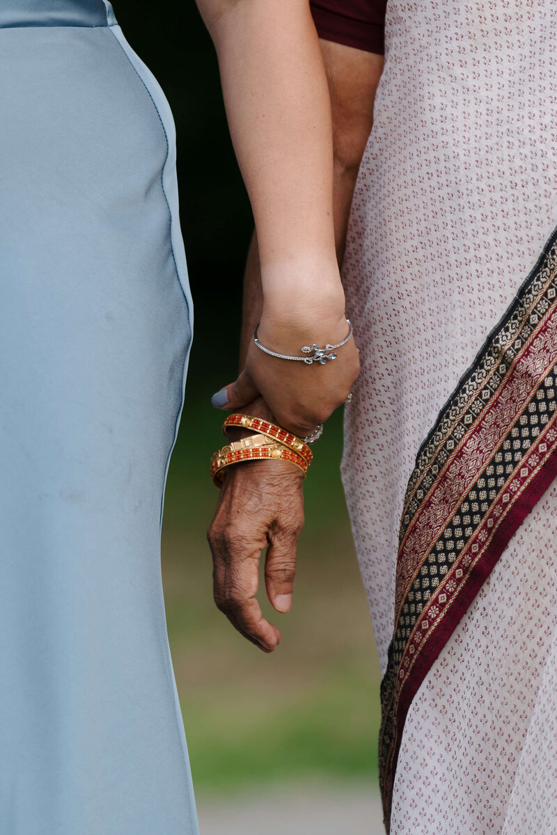 Groom holding bride's hands