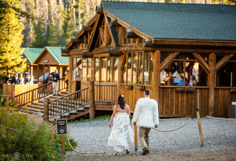 Bride and groom walk back to wedding reception at Piney River Ranch