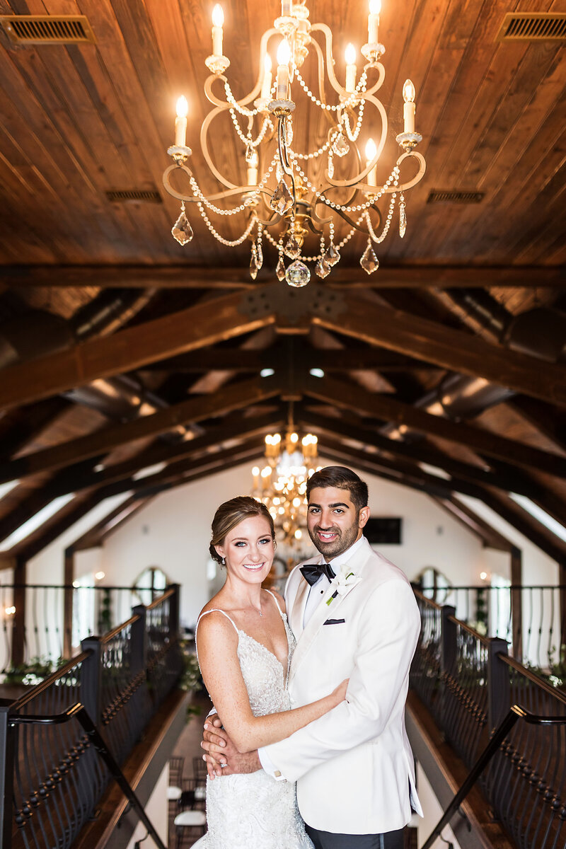 Wedding couple posing and smiling at the camera.