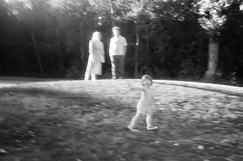 a blurry photo of a family standing on a hill