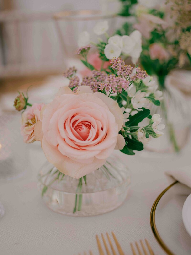 detail shot of pink rose at wedding table setting
