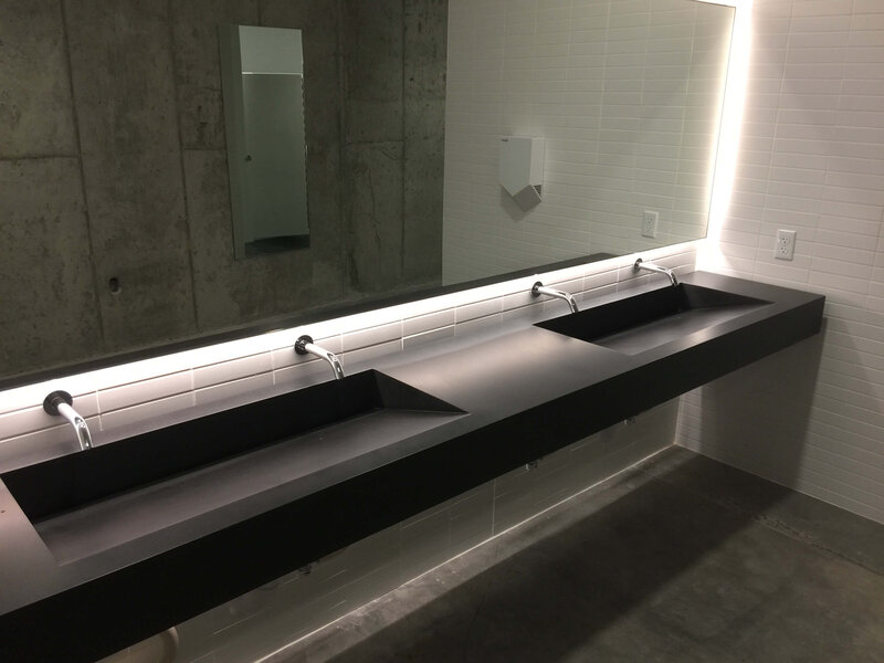 floating concrete ramp in public bathroom meets ADA-requirements two bowls and four faucets