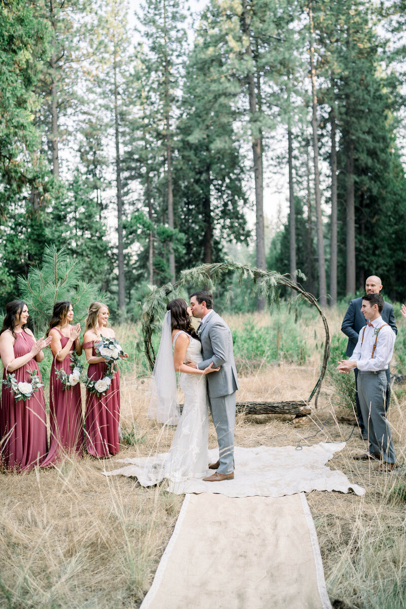 Bride and groom wedding ceremony kiss at Yosemite national park wedding in CA