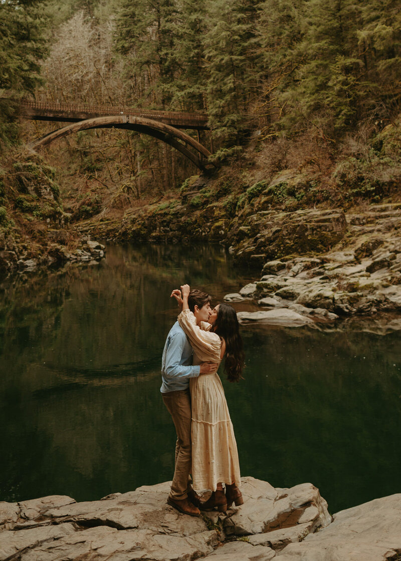 Emily-Noelle-Photography-Oregon-Elopement-Photographer-couple-standing-on-rock-next-to-lake