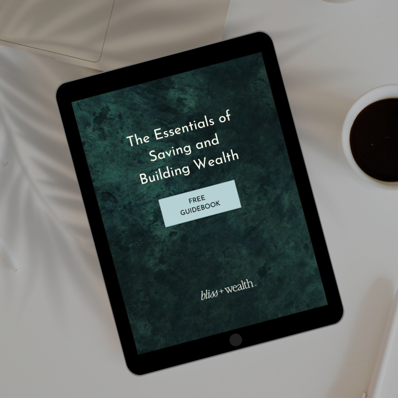 An iPad sits atop a white desk with a coffee mug and leafy shadow  in the background. The iPad reads "The Essentials of Saving and Building Wealth"- a free guidebook by money mentor, Jenny Whichello.