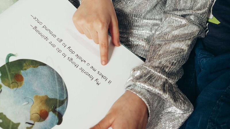 A young student reading a picture book