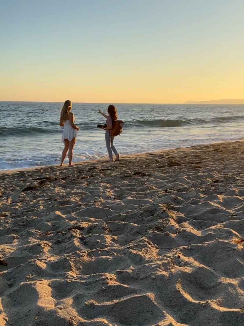 photographer and client standing on the beach looking at the sunset and ocean los angeles malibu
