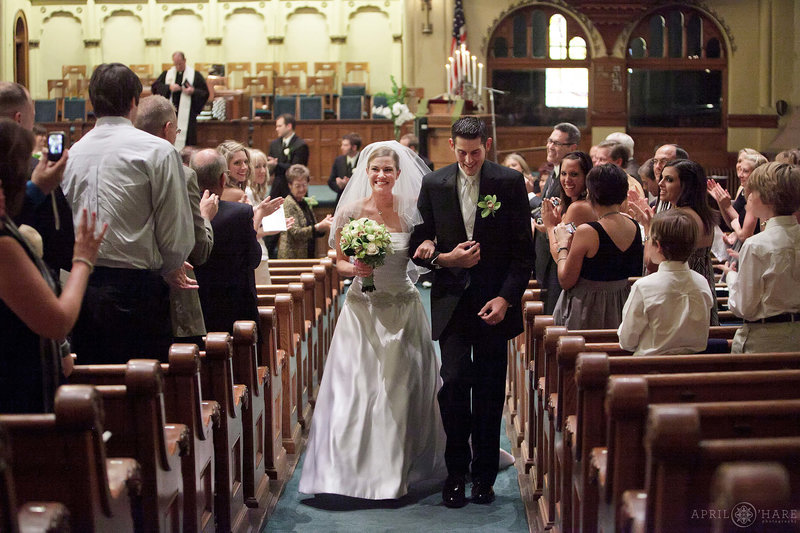 Bride and groom walk down the aisle after ceremony at Central Presbyterian Church in downtown Denver