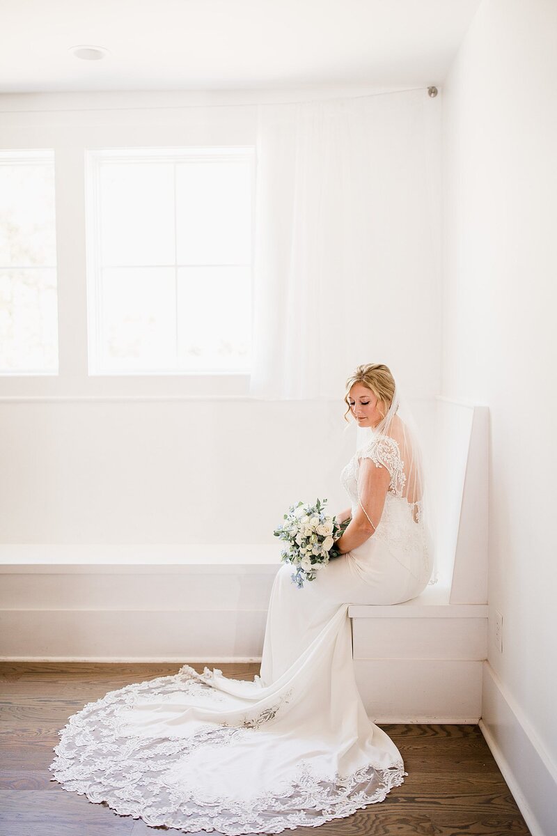 bride sitting on bench by Knoxville Wedding Photographer, Amanda May Photos