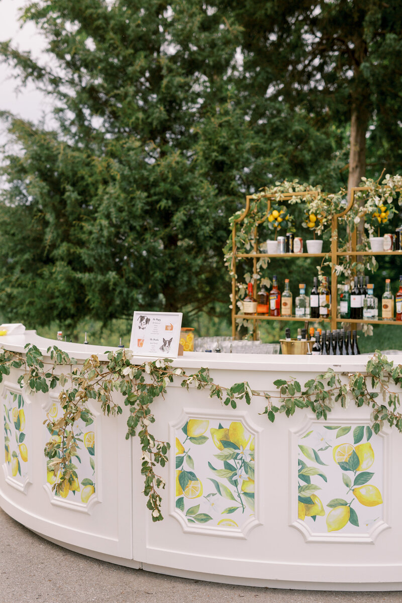 Italian-themed wedding bar with lemon and olive branch decor.
