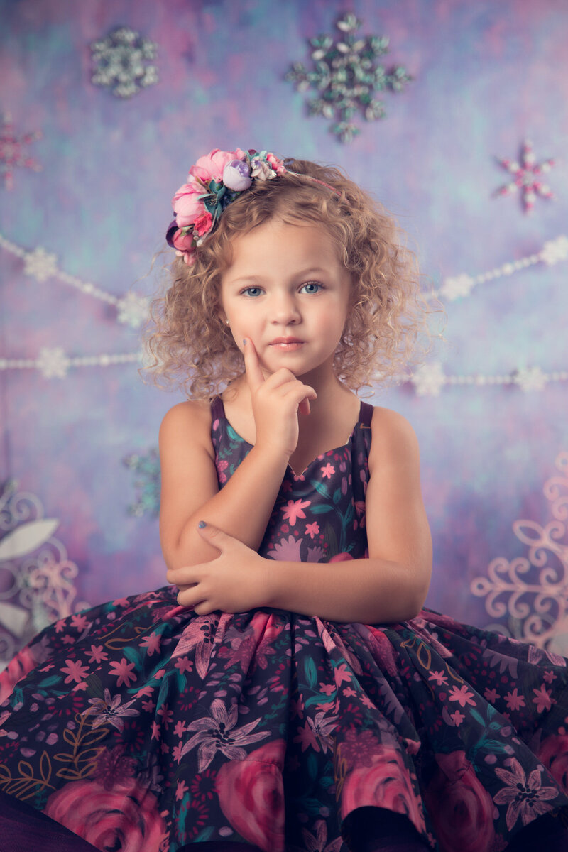 girl-in-floral-dress-with-finger-on-chin-arlington-studio