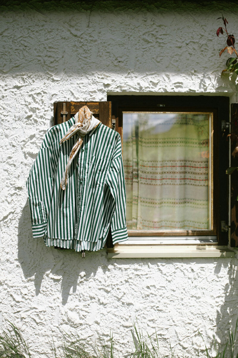 shirt hanging on window pane