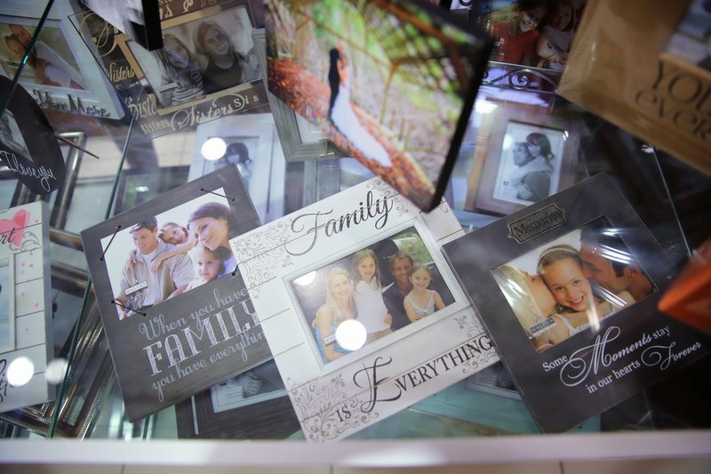 Selection of family frames in display case. By Ross Photography, Trinidad, W.I..