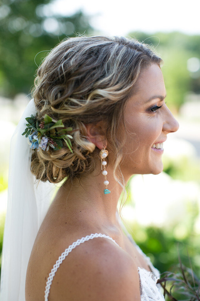 bride smiling with flowers in her hair