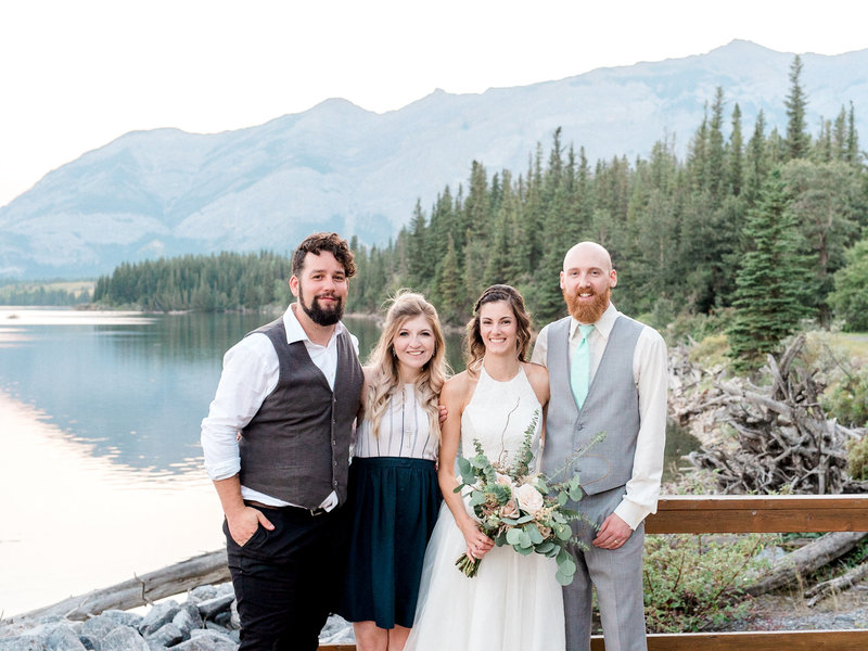 Steven and Steph posing with a bride and groom in the mountains