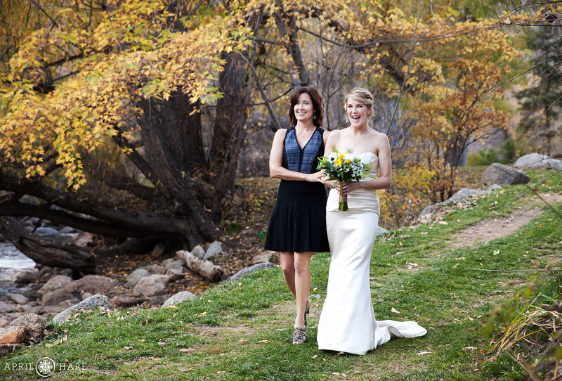 Bride walks down the aisle at her fall color wedding at Boulder Creek Wedgewood Weddings in Colorado