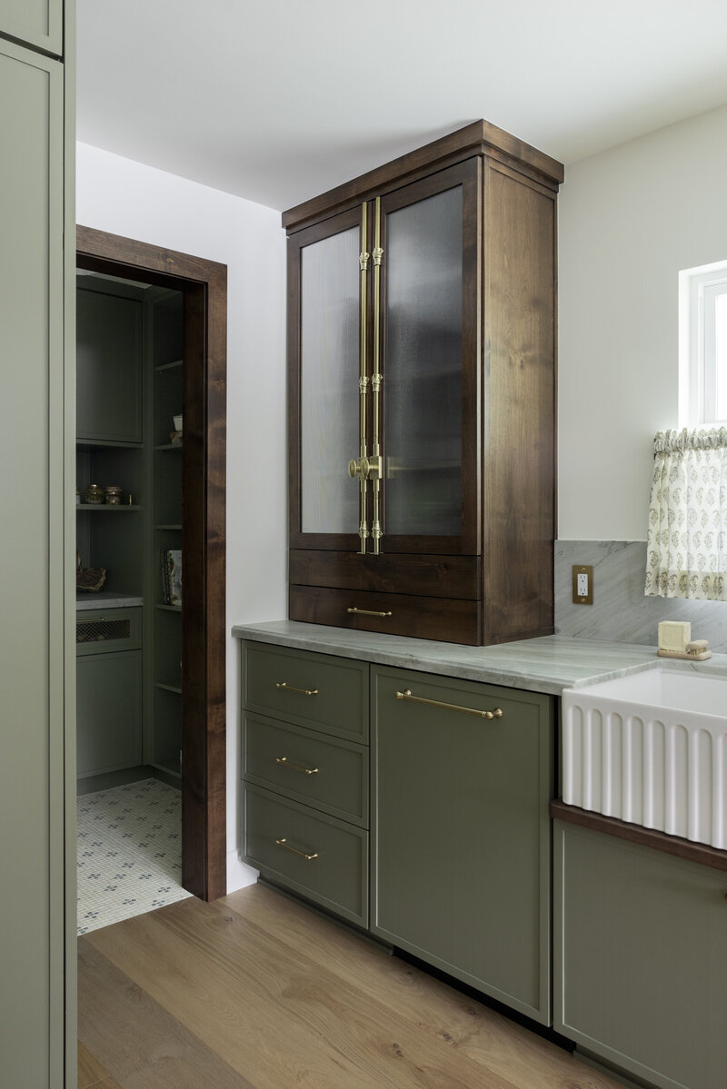 Orange county interior designer kitchen remodel. Painted cabinets with brass hardware, quartzite countertops, stained kitchen island with marble countertop and white oak wood floor.