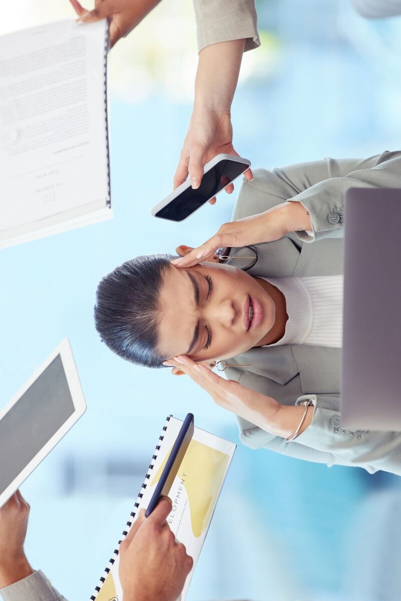 Woman holding her head appearing stressed out
