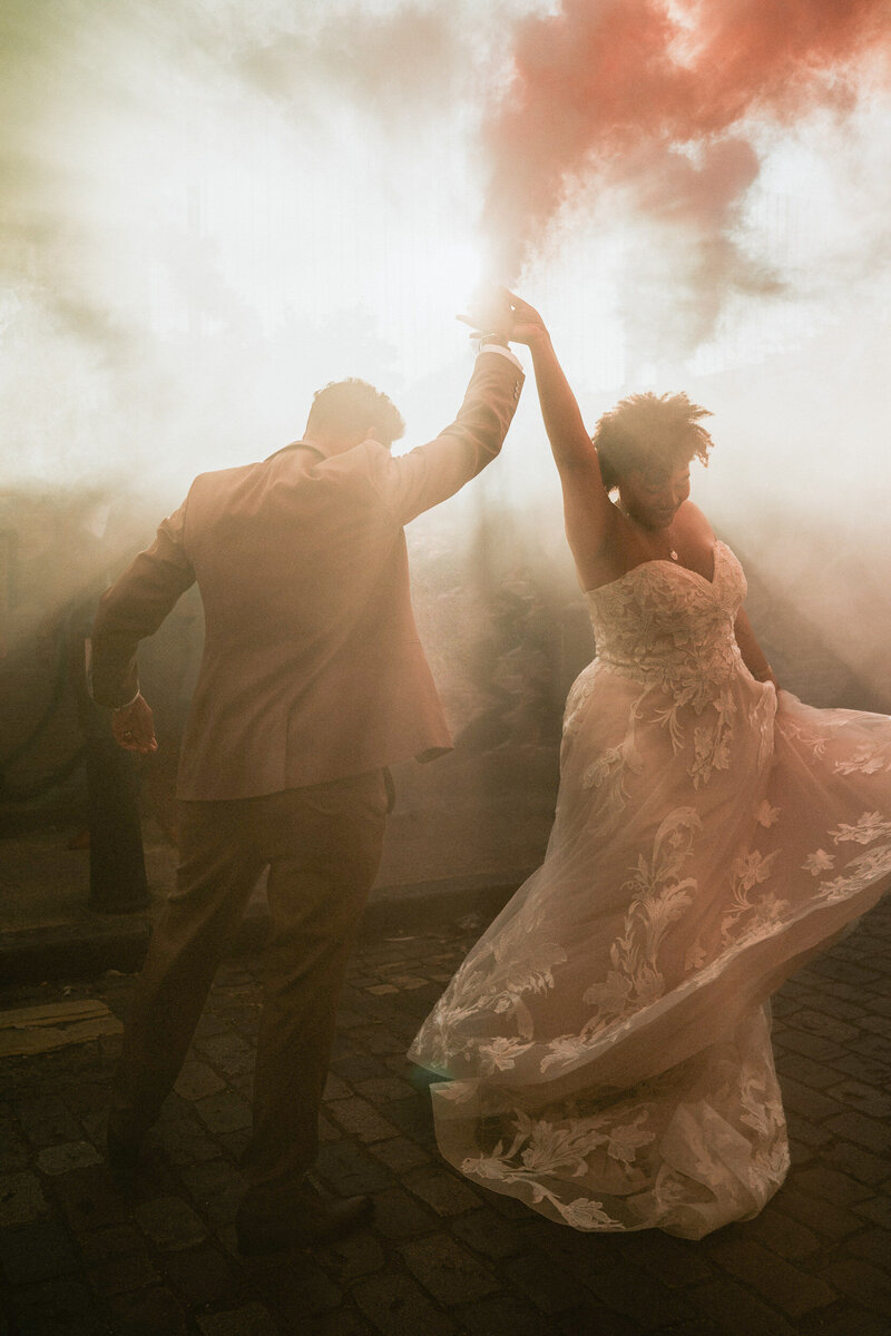 A wedding couple dancing in smoke on their wedding day.