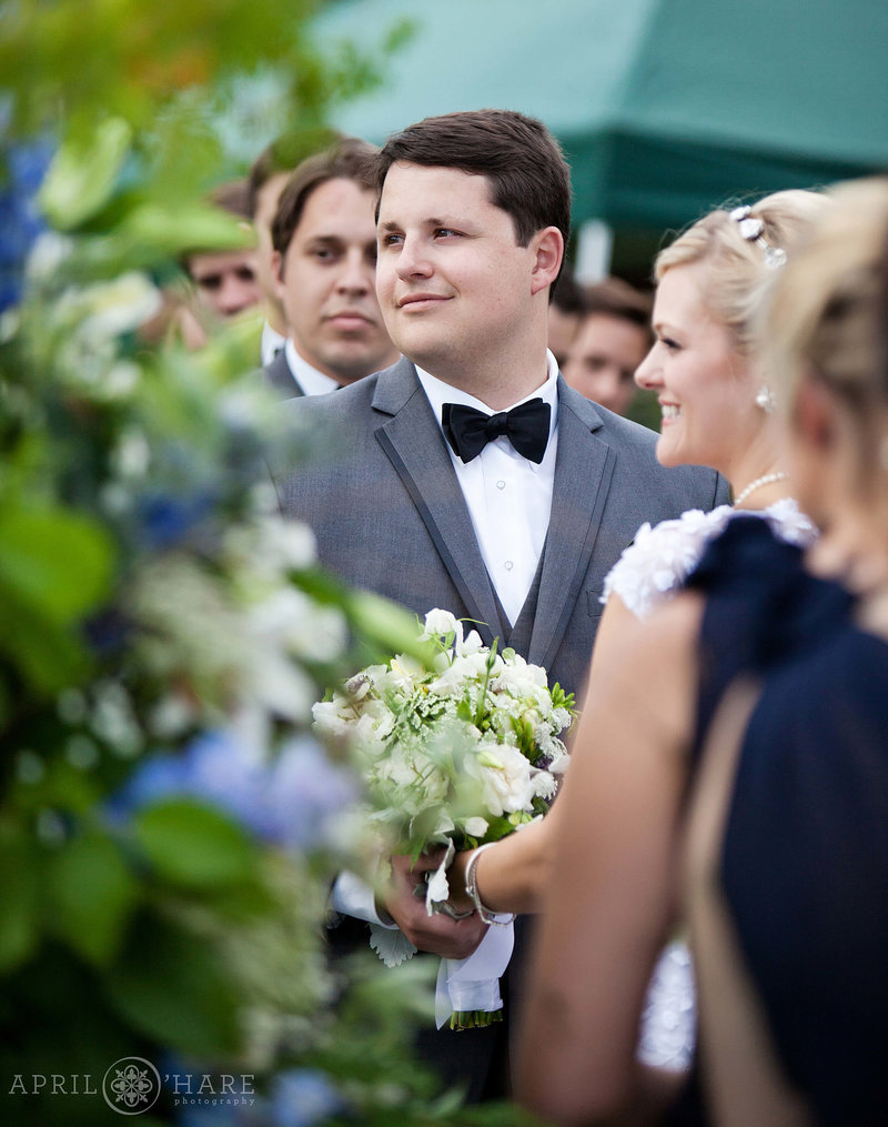 Groom on the cabin lawn at his outdoor wedding ceremony in Boulder CO at Greenbriar Inn Restaurant
