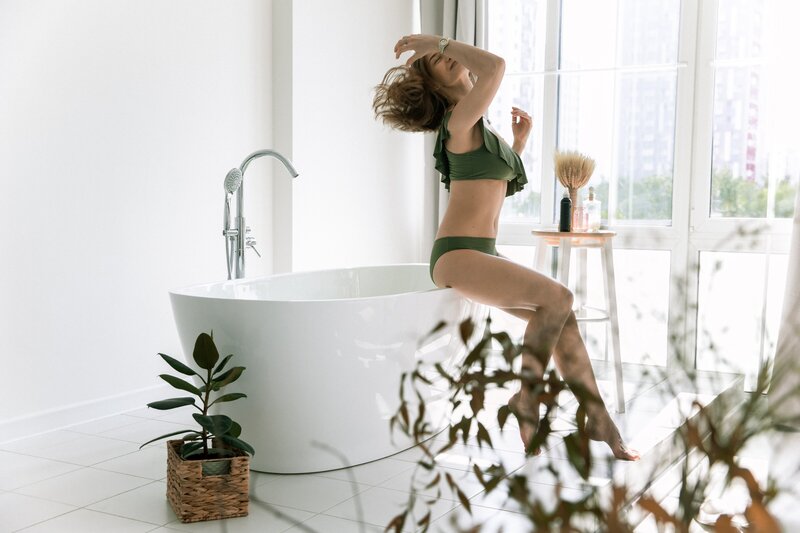 woman-in-greensexy-wear-sitting-on-bathtub-4672467