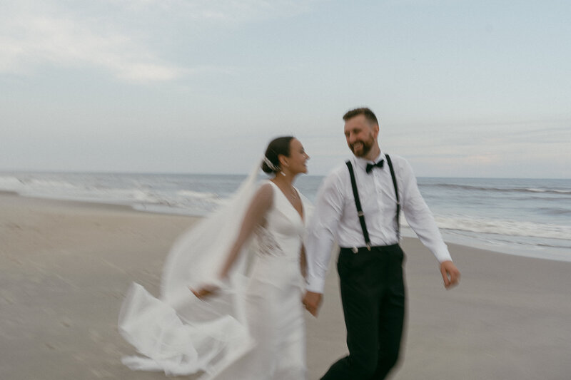 Blurry beach shot of a bride and groom.