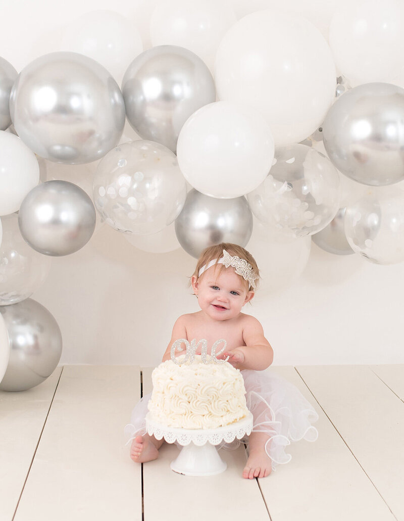 Simple silver and white cake smash for a baby girl by Laura King Photography