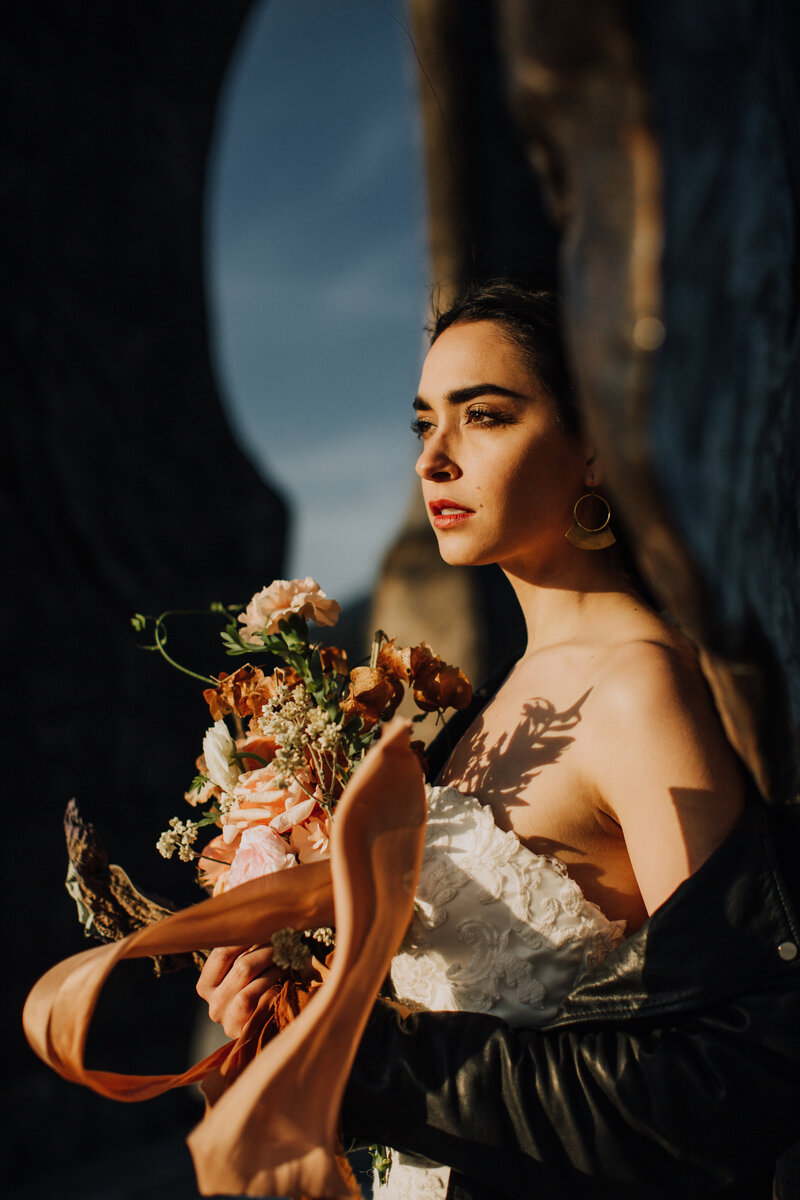 bride with golden hour light and holding bouquet