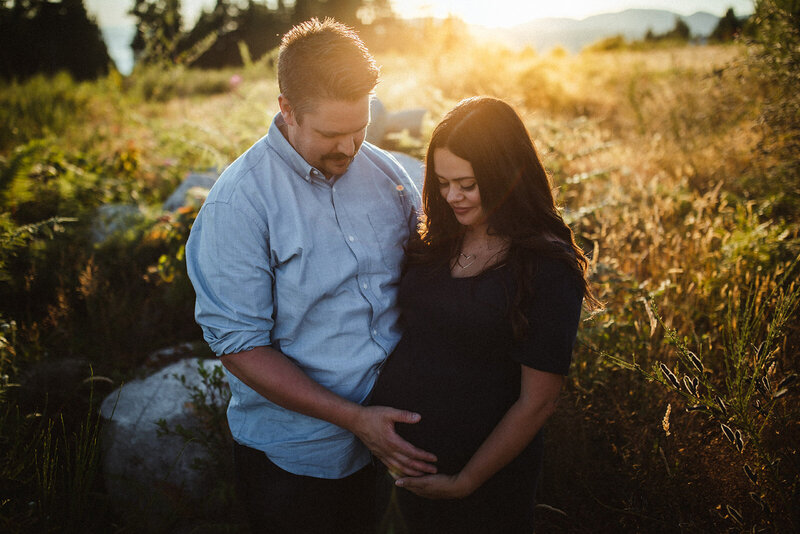 maternity portraits of a couple at havies field